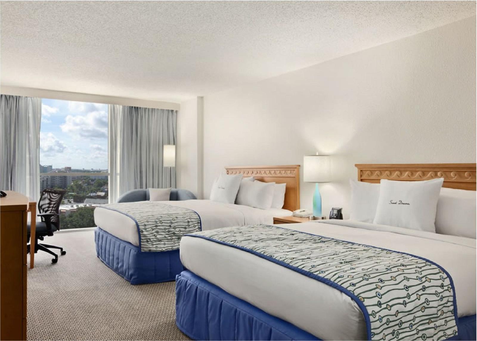 DoubleTree by Hilton Orlando — guest room with two queen beds and city view